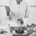 A person holding a pipette and test tube